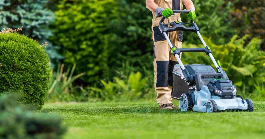 a lawnmowing professional mowing a client's lawn